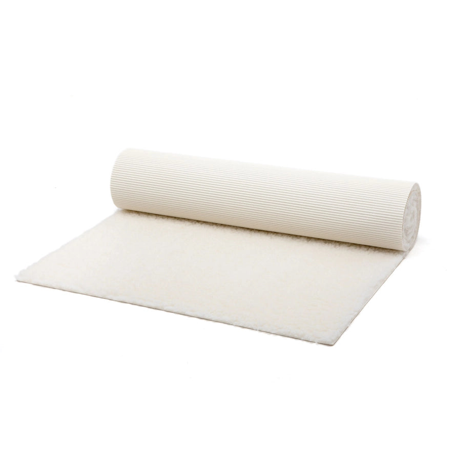 Natural wool yoga mat unrolled showing latex underside