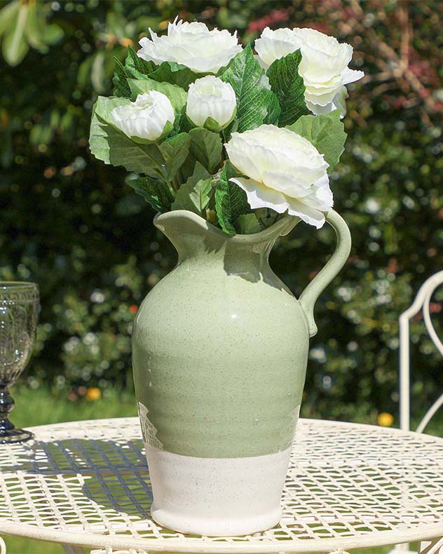 Sage green glazed ceramic jug with white flowers