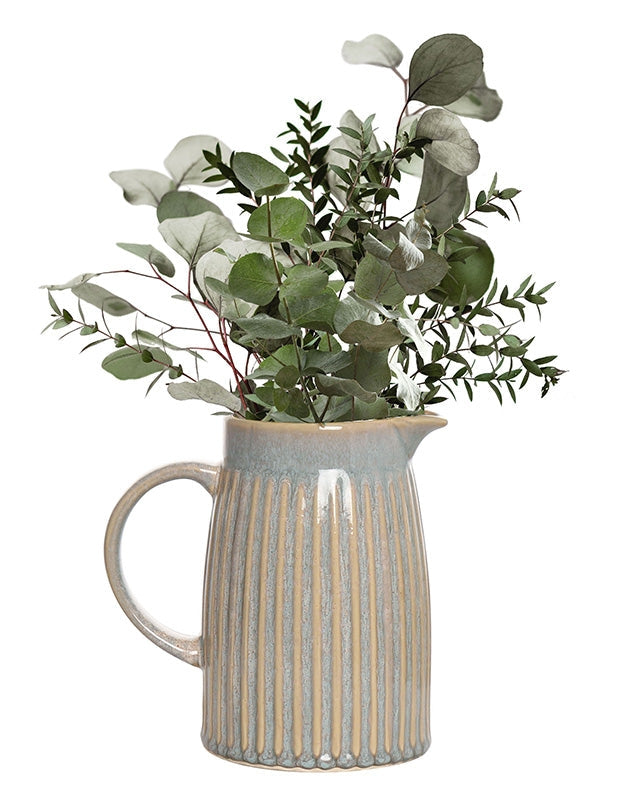 Blue pitcher vase styled as home decor